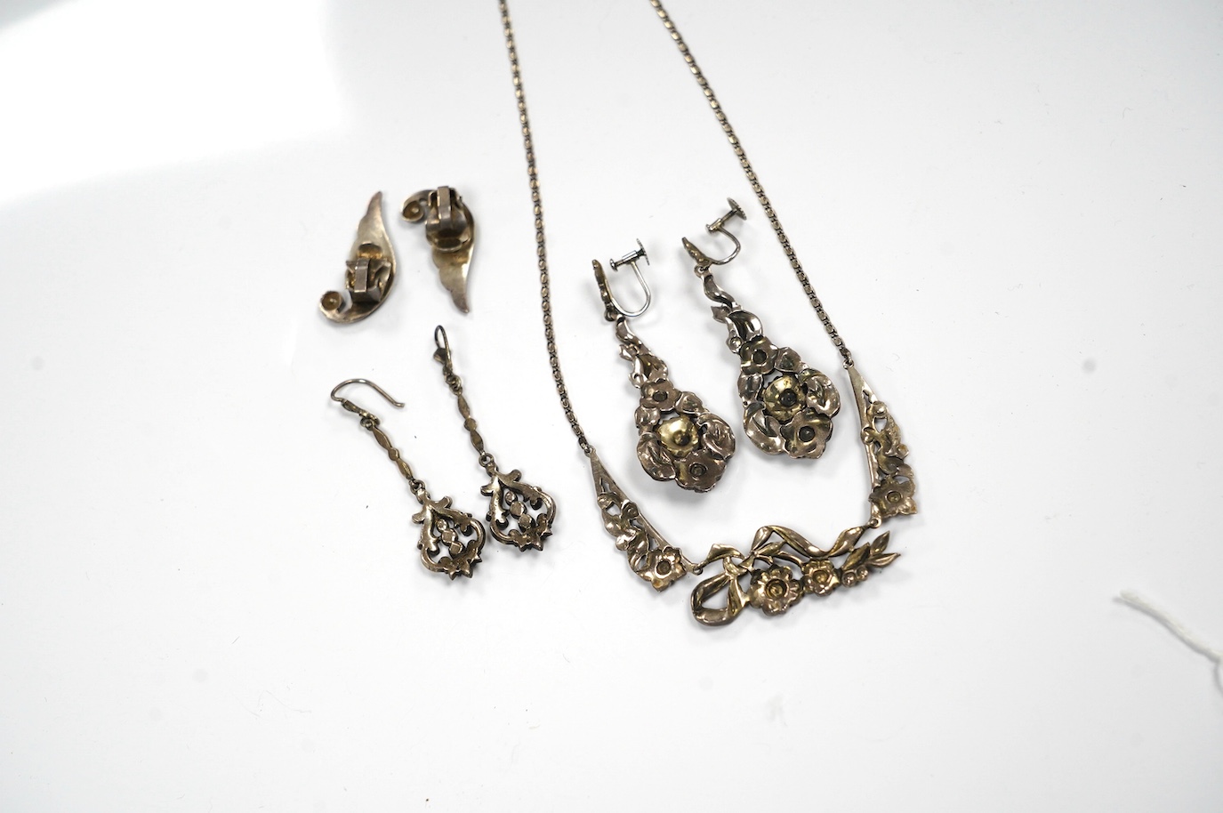 Two pairs of white metal and marcasite earrings, a similar pair of ear clips and a necklace. Condition - poor to fair